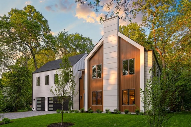 48 Sherburne Rd, Lexington, MA 02421 - contemporary house featuring a chimney, a front lawn, a garage, and driveway