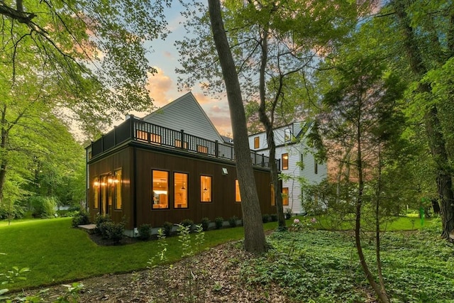 48 Sherburne Rd, Lexington, MA 02421 - back of property with a balcony, a lawn, and board and batten siding