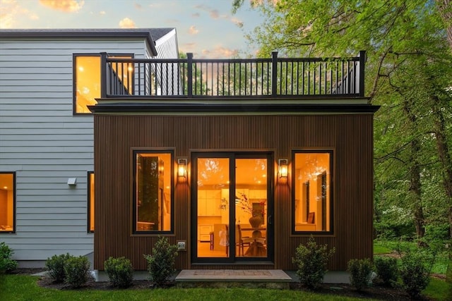 48 Sherburne Rd, Lexington, MA 02421 - back of house at dusk featuring a balcony