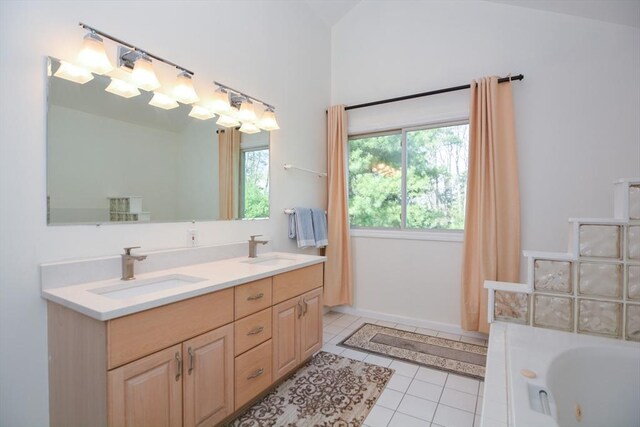bathroom featuring tile patterned flooring, a sink, a whirlpool tub, and double vanity