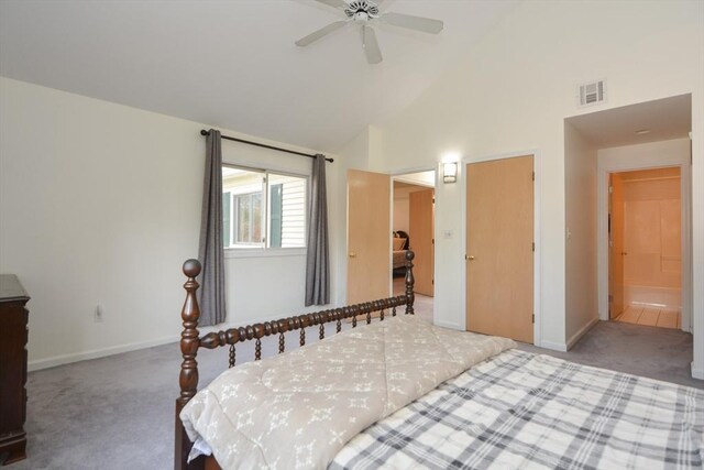carpeted bedroom featuring high vaulted ceiling, baseboards, and visible vents