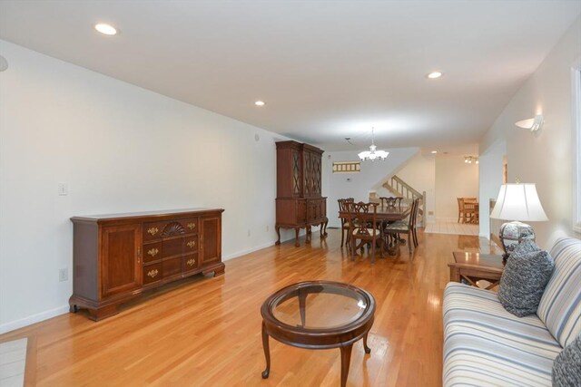 living area featuring recessed lighting, baseboards, a chandelier, and light wood finished floors