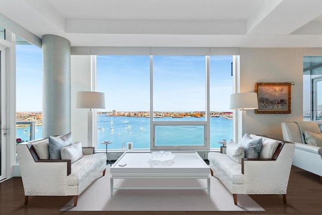 living room with wood finished floors and a water view