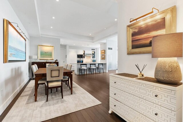dining room with dark wood-style flooring, recessed lighting, and baseboards