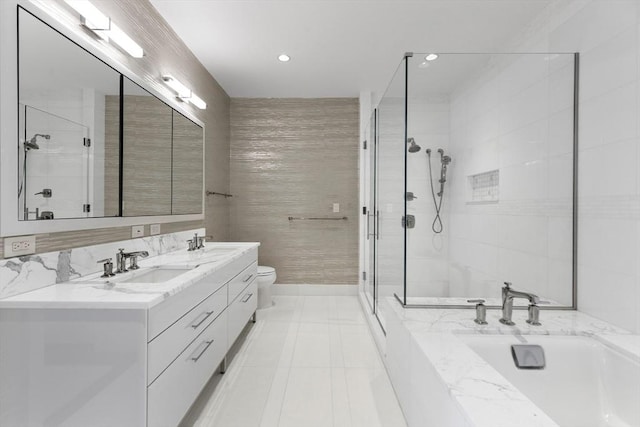 bathroom with a stall shower, toilet, double vanity, recessed lighting, and tile patterned floors