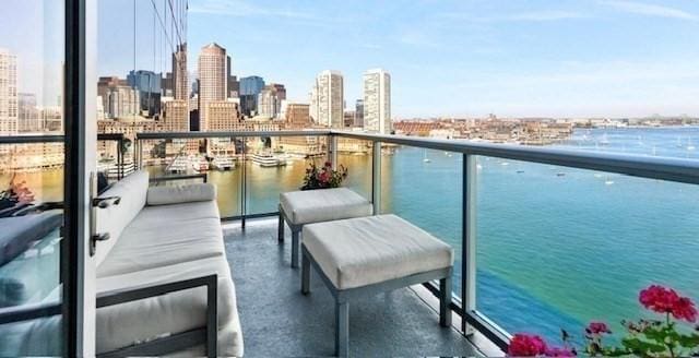 balcony with a view of skyline and a water view