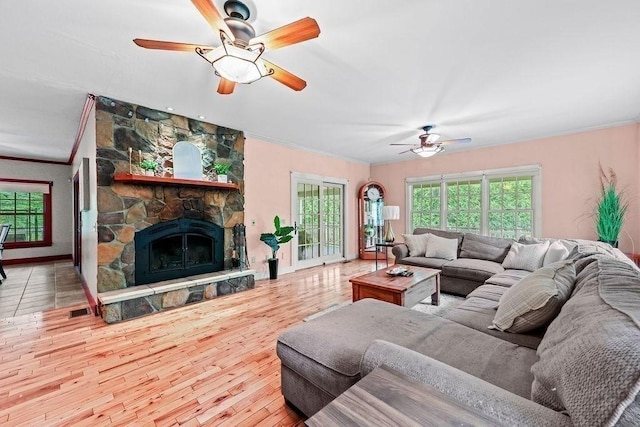 311 River Rd, South Hadley, MA 01075 - living room with a ceiling fan, crown molding, wood finished floors, a fireplace, and baseboards