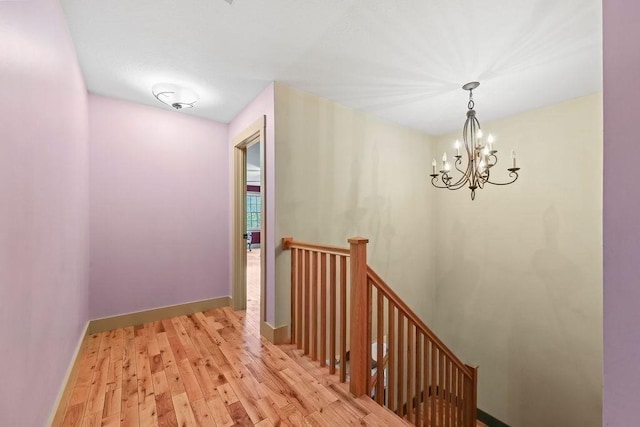 311 River Rd, South Hadley, MA 01075 - hallway with an upstairs landing, a chandelier, light wood finished floors, and baseboards
