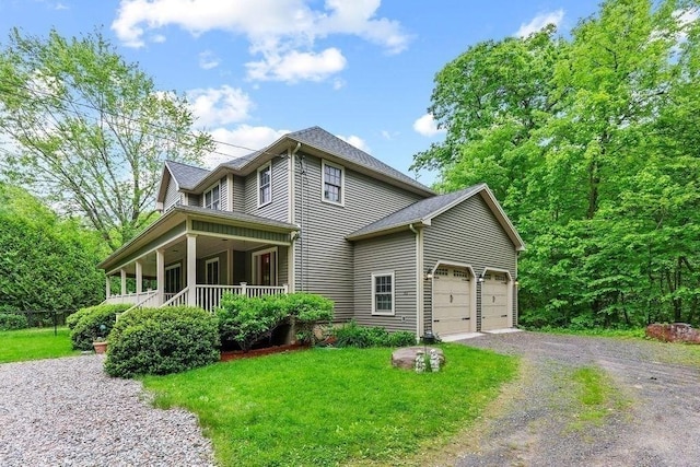 311 River Rd, South Hadley, MA 01075 - view of front facade with covered porch, gravel driveway, a front yard, and a garage