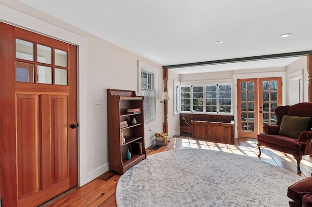 sitting room with baseboards, french doors, light wood-style flooring, and recessed lighting