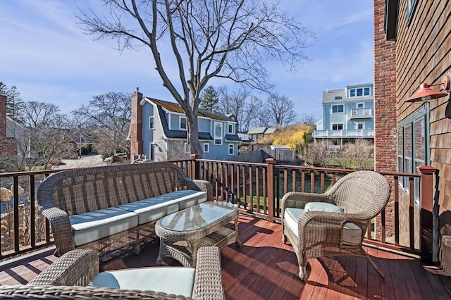 wooden deck featuring outdoor lounge area and a residential view