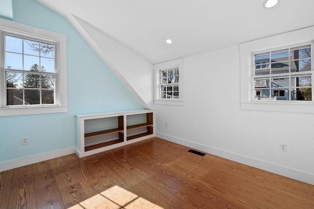 bonus room with wood finished floors, visible vents, recessed lighting, vaulted ceiling, and baseboards