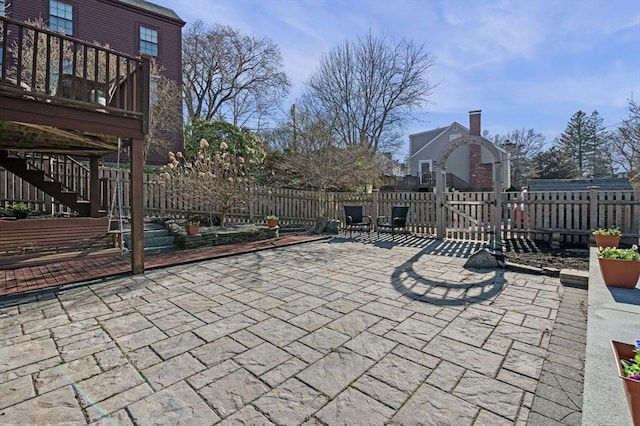 view of patio / terrace with a gate, fence, a deck, and stairway