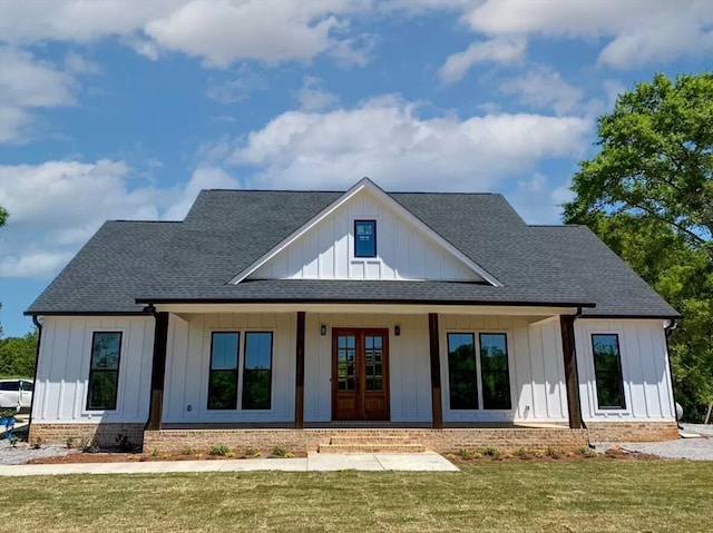 rear view of property with a lawn