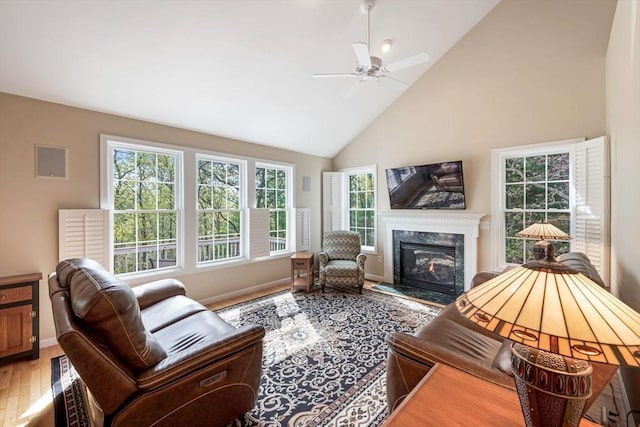 40 Canoe Lndg, Plymouth, MA 02360 - living area featuring plenty of natural light, high vaulted ceiling, a ceiling fan, wood finished floors, and a premium fireplace