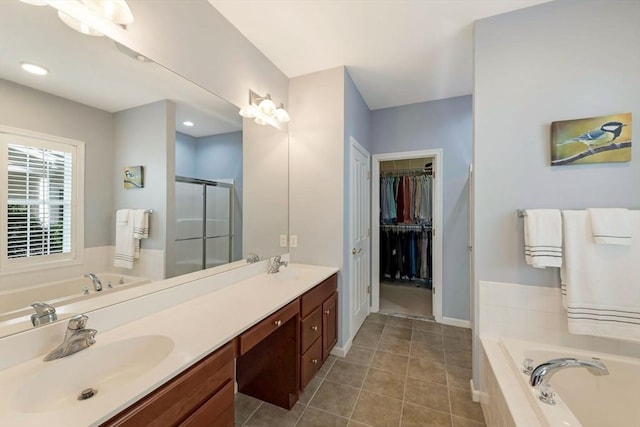 40 Canoe Lndg, Plymouth, MA 02360 - bathroom featuring a garden tub, tile patterned floors, a stall shower, double vanity, and a walk in closet
