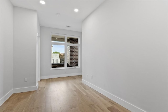 empty room featuring recessed lighting, visible vents, baseboards, and light wood finished floors