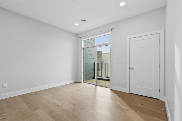 unfurnished bedroom featuring visible vents, access to outside, wood finished floors, recessed lighting, and baseboards