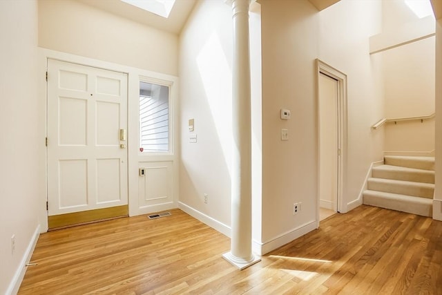 25 Hopewell Farm Rd Unit 25, Natick, MA 01760 - entryway featuring light wood-style floors, baseboards, stairway, decorative columns, and a skylight