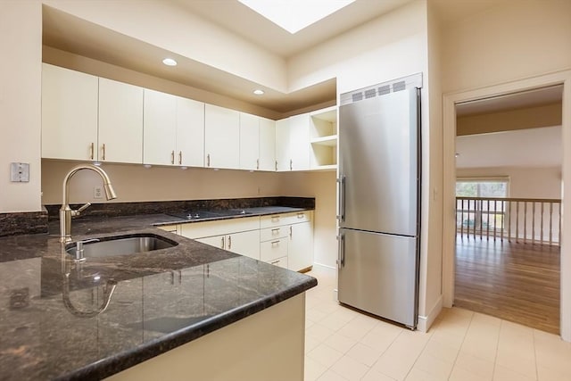 25 Hopewell Farm Rd Unit 25, Natick, MA 01760 - kitchen featuring stainless steel refrigerator, a sink, dark stone countertops, recessed lighting, and white cabinetry