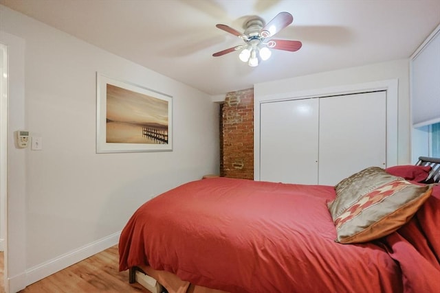 33 Inman St Unit 1B, Cambridge, MA 02139 - bedroom with light wood-style floors, a closet, and a ceiling fan