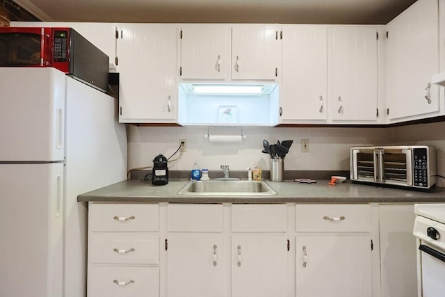 33 Inman St Unit 1B, Cambridge, MA 02139 - kitchen featuring freestanding refrigerator, white cabinets, and stove