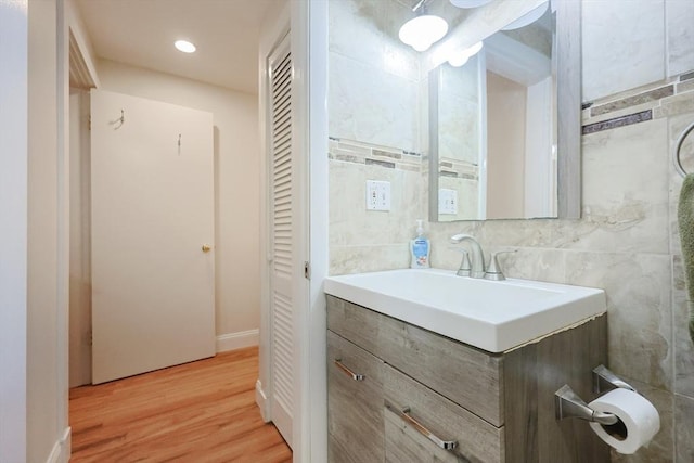 33 Inman St Unit 1B, Cambridge, MA 02139 - bathroom with vanity, wood finished floors, a closet, recessed lighting, and tile walls