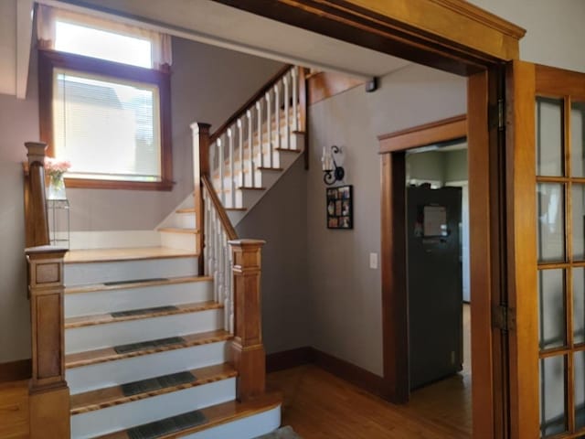 stairs featuring baseboards and wood finished floors