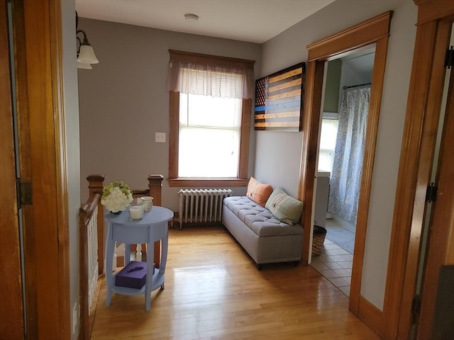 sitting room featuring light wood-style floors and radiator