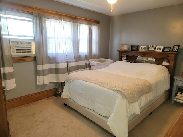 bedroom featuring multiple windows, cooling unit, baseboards, and carpet floors