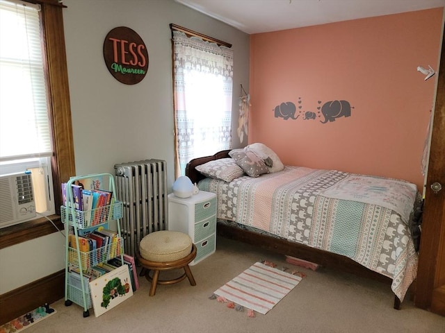 carpeted bedroom featuring multiple windows and radiator