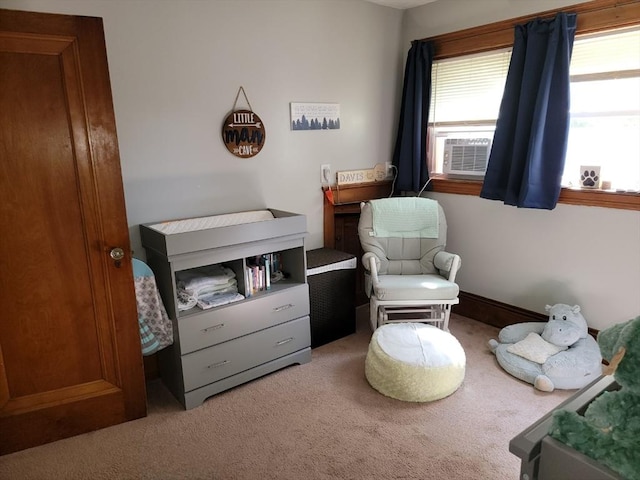 living area featuring cooling unit and carpet floors