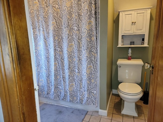 full bathroom with tile patterned flooring, toilet, and baseboards