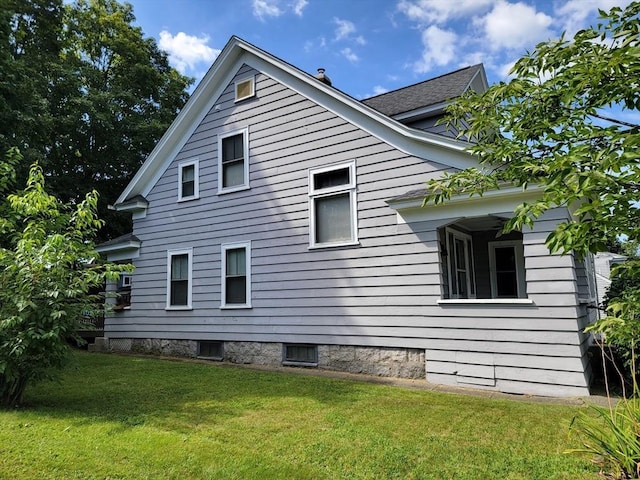 view of property exterior featuring a lawn