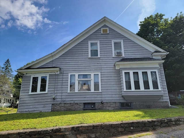 view of side of property featuring cooling unit and a yard