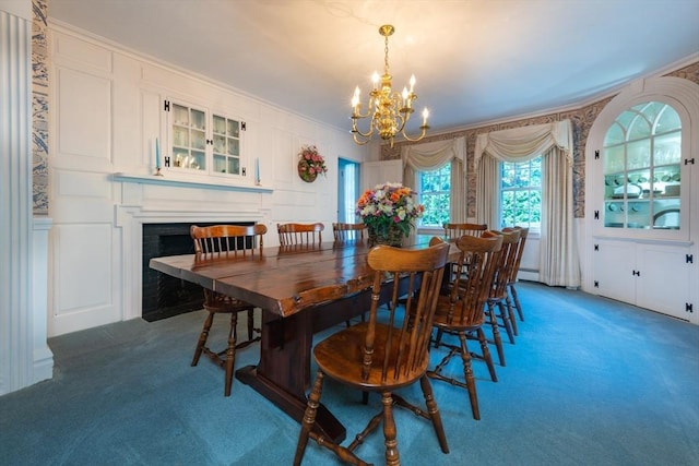 192 W Main St, Westborough, MA 01581 - carpeted dining space with a baseboard radiator, a fireplace with flush hearth, crown molding, a decorative wall, and a chandelier