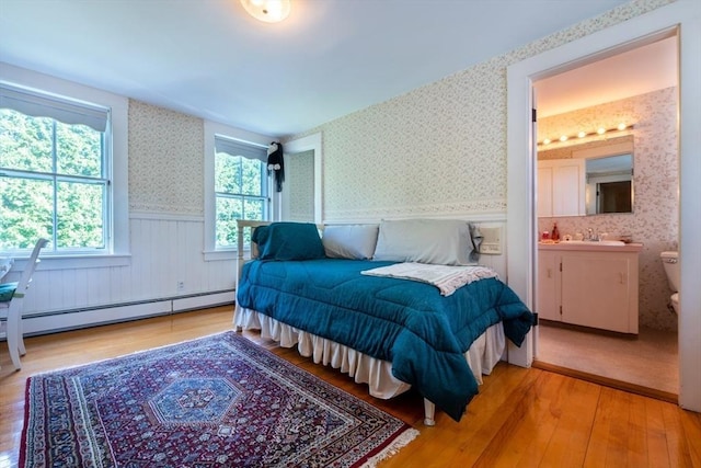 192 W Main St, Westborough, MA 01581 - bedroom featuring light wood-type flooring, ensuite bath, wainscoting, wallpapered walls, and baseboard heating