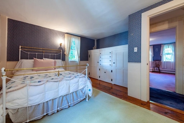 192 W Main St, Westborough, MA 01581 - bedroom featuring wallpapered walls, multiple windows, a baseboard heating unit, and wainscoting