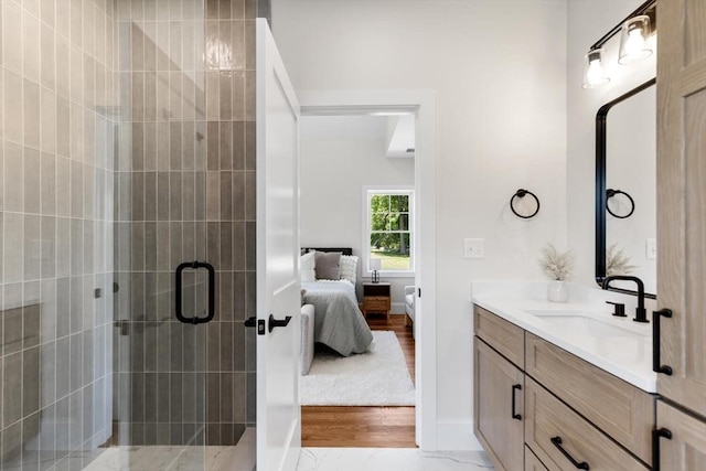 28 Marlboro Rd, Woburn, MA 01801 - ensuite bathroom featuring vanity, a shower stall, wood finished floors, and baseboards