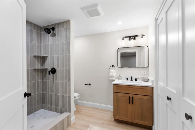28 Marlboro Rd, Woburn, MA 01801 - full bath with vanity, toilet, tiled shower, wood finished floors, and baseboards