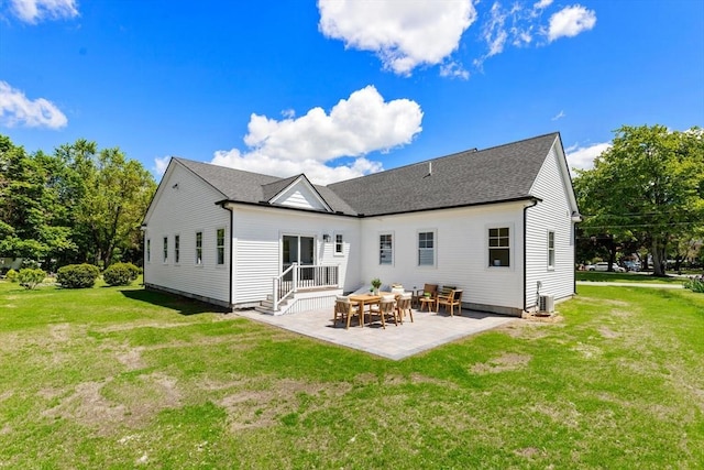 28 Marlboro Rd, Woburn, MA 01801 - back of house featuring a patio area, a yard, central AC, and roof with shingles