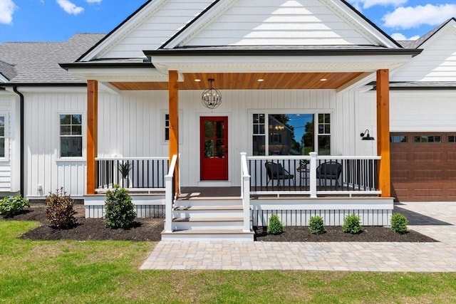 28 Marlboro Rd, Woburn, MA 01801 - view of front facade with a porch, an attached garage, and roof with shingles