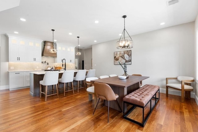 28 Marlboro Rd, Woburn, MA 01801 - dining room with light wood-style flooring, recessed lighting, baseboards, and a chandelier