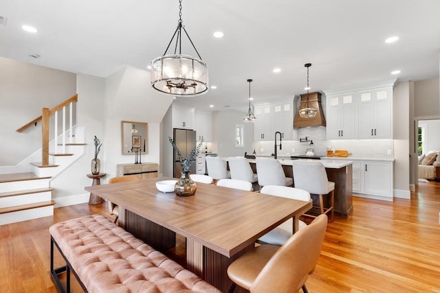 28 Marlboro Rd, Woburn, MA 01801 - dining room featuring light wood-style floors, recessed lighting, stairs, a chandelier, and baseboards