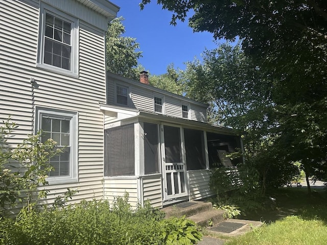 24 Main St, Monson, MA 01057 - view of front facade with a chimney and a sunroom