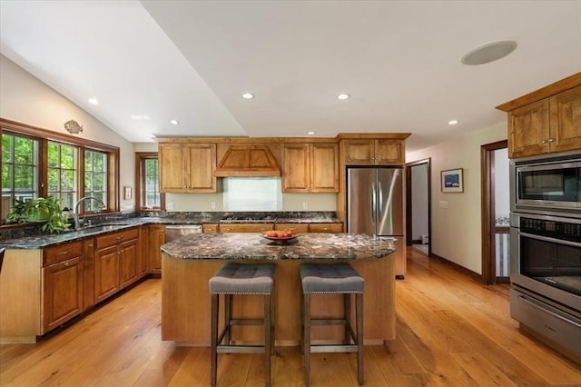94 Middleton Rd, Boxford, MA 01921 - kitchen with appliances with stainless steel finishes, a kitchen island, a sink, dark stone countertops, and light wood-type flooring