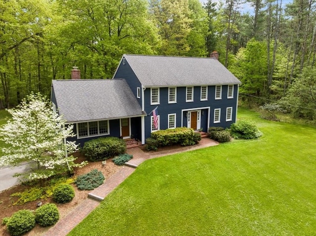 94 Middleton Rd, Boxford, MA 01921 - colonial-style house with a chimney, a front yard, and a view of trees