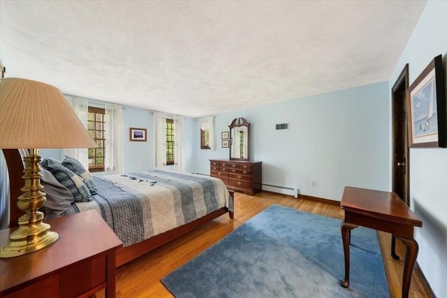 94 Middleton Rd, Boxford, MA 01921 - bedroom featuring a baseboard radiator, wood finished floors, and baseboards
