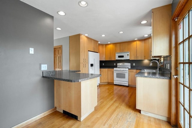 4 Hadwen Rd, Worcester, MA 01602 - kitchen featuring white appliances, dark countertops, a sink, a peninsula, and baseboards
