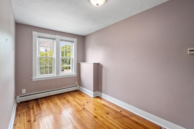 4 Hadwen Rd, Worcester, MA 01602 - spare room featuring a baseboard radiator, baseboards, and light wood finished floors